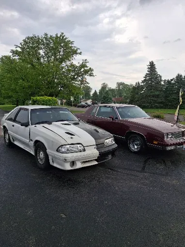 A Fox-body Mustang GT and an '80s Cutlass in the shop lot